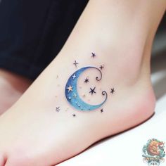 a woman's foot with stars and a crescent tattoo on the bottom of it