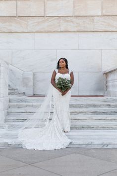 a woman in a wedding dress standing on steps