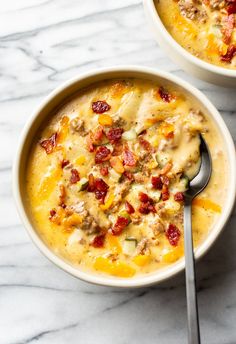 two bowls filled with soup on top of a table