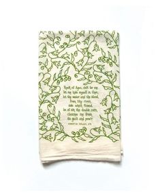 a white towel with green leaves on it and a poem written in cursive writing