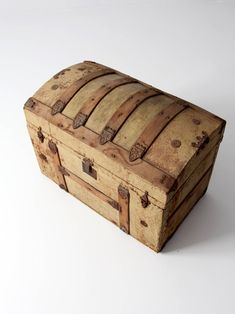 an old wooden trunk sitting on top of a white table