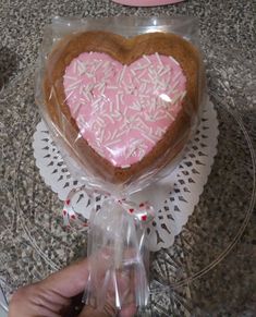 a heart shaped cookie is wrapped in plastic