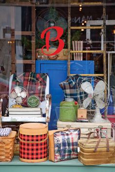 many different types of items are displayed in a store window with the letter b on it