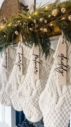 christmas stockings hanging from a mantel with name tags