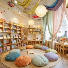 the children's room is decorated in pastel colors and has round pillows on the floor