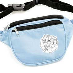 a blue fanny bag with a mountain scene on the front and mountains in the back