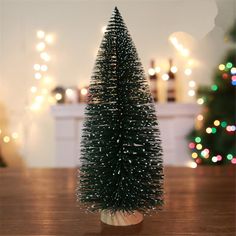 a small christmas tree sitting on top of a wooden table