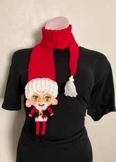 a knitted hat and scarf on top of a mannequin