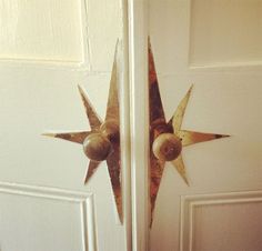 the door is open and there are two metal star decorations on each side of the door