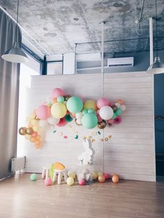 a room with balloons and toys on the floor