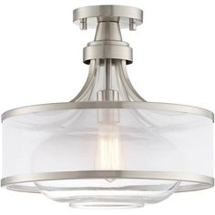 a semi flush ceiling light with clear glass shades