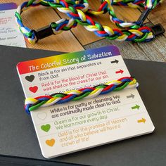 the colorful story of salvation bracelets are on top of a black binder with instructions