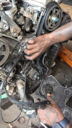 a person working on an engine in a garage