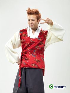 a young man wearing a red and white outfit with his hands on his head while standing in front of a white background