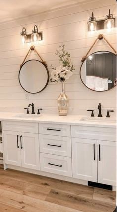 a bathroom with two sinks and mirrors on the wall