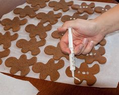 a person is decorating cookies and cakes like a pro with a white crayon marker