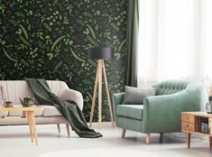 a living room with green and black wallpaper, two couches and a lamp