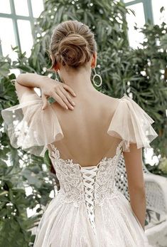 the back of a woman wearing a wedding dress