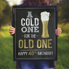 a woman holding up a sign that says, a cold one for the old one happy fortyth birthday