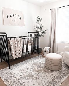 a baby's room is decorated in white and black