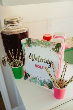 there is a sign that says waiting hole next to some cups with straws in them