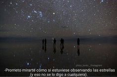 three people are standing under the stars in the sky