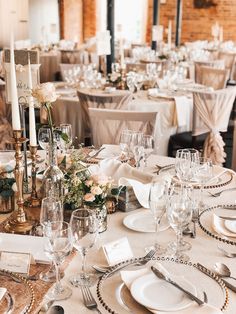 the tables are set with white linens and place settings for an elegant wedding reception