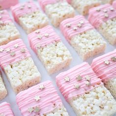 rice krispy treats with pink icing and gold stars on them are ready to be eaten