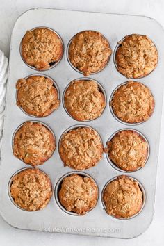 freshly baked muffins sitting in a muffin tin ready to be eaten for breakfast