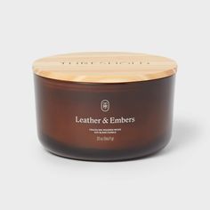 the leather & embers candle in brown with wooden lid