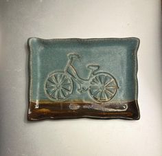 a ceramic plate with a bicycle on it