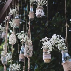 hanging mason jars filled with baby's breath flowers and twine rope for decoration