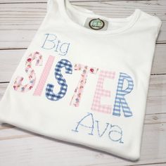 Big sister shirt Help big sister feel an important part of the day, which she is! Adorable applique shirt to proudly announce she is now a big sister! Available in short or long sleeve. Ships within 5-7 business days Thanks for shopping with Sew Blessed Stitches! Please visit our sister store at www.runningrosecreations.etsy.com We would love to connect with you on social media. You can find us at: Instagram - @sewblessedstitches Facebook - facebook.com/sewblessedstitches Email - sewblessedstitc Personalized Cotton T-shirt For Gender Reveal, Embroidered Cotton Top For Birthday, Cute Cotton Shirt For Gender Reveal, Personalized Cute Cotton Shirt, Cute Personalized Cotton Shirt, Cute Cotton Shirt With Name Print, Personalized Short Sleeve Cotton Shirt, Cute Customizable Cotton Shirt, Sister Matching Shirts