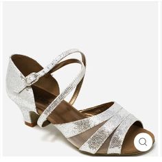 a pair of women's shoes with straps and heels on the bottom, in silver glitter