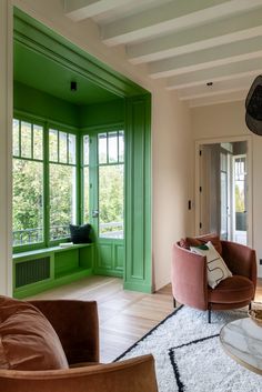 a living room filled with furniture and green doors