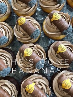 there are many cupcakes with chocolate frosting on them and one has a banana in the middle