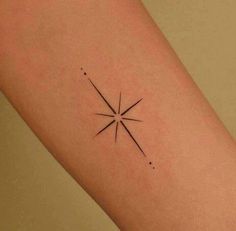 a small star tattoo on the right arm and leg, with dots around it in black ink