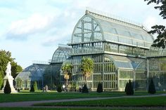 a large glass building sitting in the middle of a park