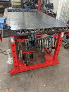 a workbench with tools and wrenches on it in a garage or workshop