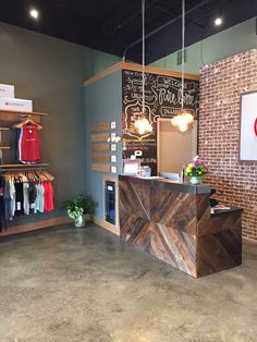 the inside of a clothing store with brick walls