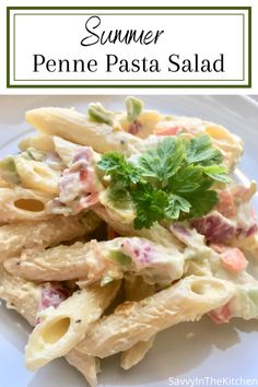 pasta salad on a white plate with the title text overlay reads summer penne pasta salad