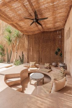 an outdoor living area with couches and tables