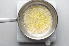 a pan filled with food sitting on top of a stove