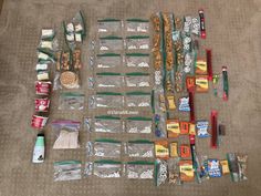 an assortment of snacks and condiments laid out on the floor next to each other