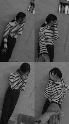 a girl in striped shirt leaning against wall talking on cell phone and holding her hand up to her face