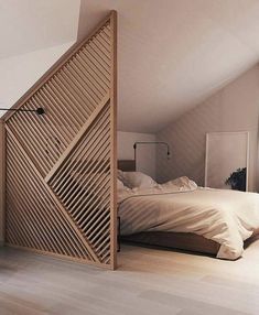 a bed sitting in the middle of a bedroom next to an open door that is on top of a hard wood floor