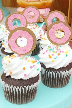 there are cupcakes with donuts on top of them