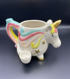 a ceramic cup with a unicorn design on it