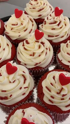 red velvet cupcakes with white frosting and hearts