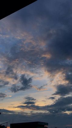 the sky is very dark and cloudy at night time, with some clouds in the foreground